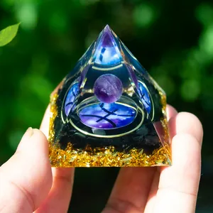 Detailed macro of Pisces Orgone Pyramid with amethyst sphere and gold foil flakes