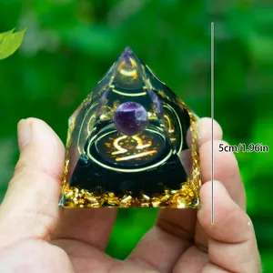 Detail view of 5cm Orgone pyramid with Libra symbol, amethyst ball, and gold foil