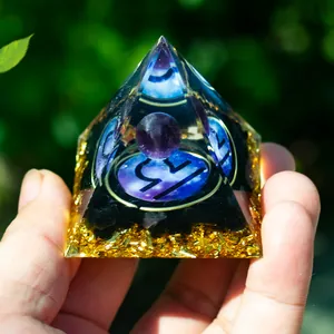 Detail of Orgone pyramid featuring Libra symbol, amethyst ball, and golden leaf accents