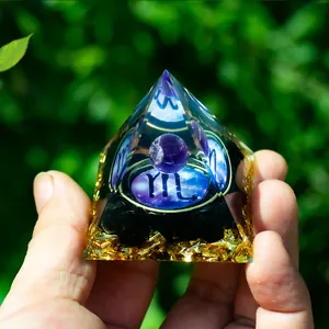 Detailed view of Scorpio resin pyramid with amethyst ball, gold foil and black obsidian stones