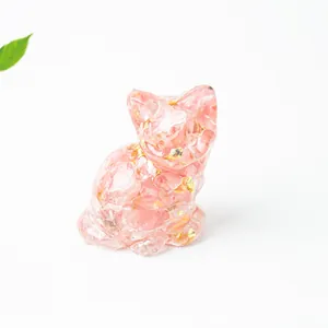 Detail of cute resin sitting cat ornament with pink crystal stones and gold leaf flakes