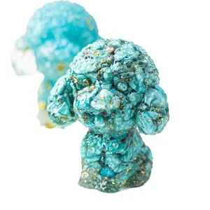 Pair of turquoise resin poodle statues with gold leaf flakes on a clean white background