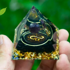 Macro shot of Leo zodiac Orgone pyramid with amethyst ball and obsidian base details