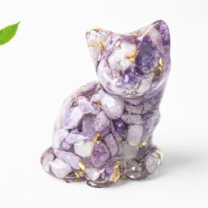 Detailed close-up of a resin cat figurine with purple amethyst stones and gold leaf flakes