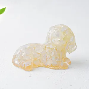 Top view of a translucent yellow crystal dog ornament with faceted resin texture details