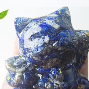 Close-up of blue lapis lazuli crystal cat statue with gold foil accents and resin finish