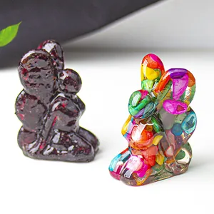 Detail of fairy figurines made from purple and multi-color crystal gravel in resin