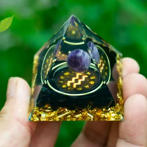 Orgone energy pyramid with amethyst ball and glowing Aquarius zodiac sign in resin