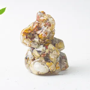 Detail of crystal resin elephant statue with colorful natural stones and smooth finish