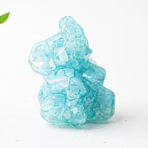 Close-up of a blue resin elephant figurine with embedded natural crystal stones