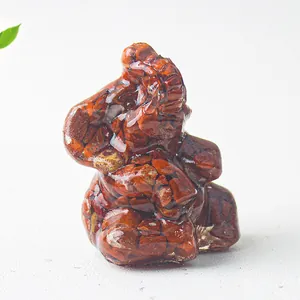 Macro shot of an elephant figurine with red jasper crystal stones and clear resin finish