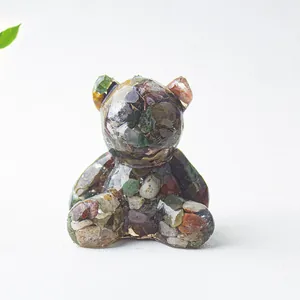 Dettaglio di un orsetto in resina con cristalli naturali colorati per decorazione casa