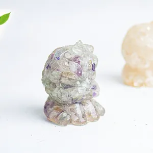 Detail of resin creature ornament embedded with purple and green fluorite crystals
