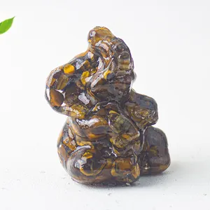 Macro detail of polished Tiger Eye Ganesha elephant figurine with natural stone texture
