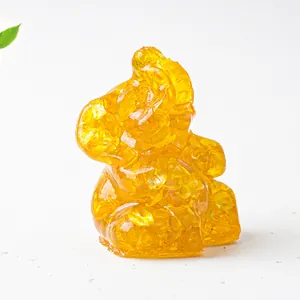 Macro shot of transparent amber resin Ganesha elephant statue with crystal shards