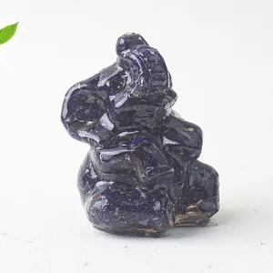 Close-up of sparkling blue sandstone elephant figurine on a neutral textured background