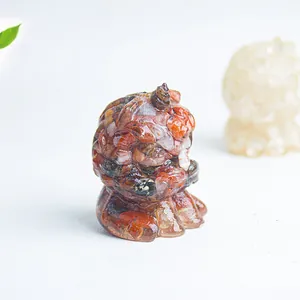 Macro shot of resin lion figurine filled with red-brown natural crystal stones and minerals