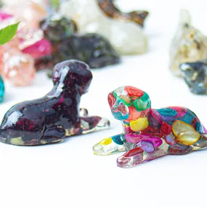 Macro shot of sleeping dog figurines with colorful natural crystal stone resin inside