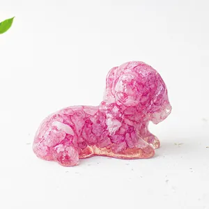 Macro shot of a pink natural crystal stone resin dog ornament on a white background