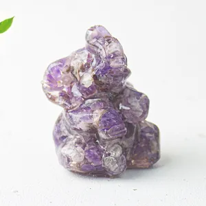 Macro shot of purple crystal chips in resin elephant figurine on a white surface