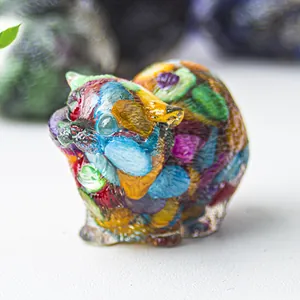 Detailed macro view of an artistic resin cat figurine with colorful crystal stone inlay