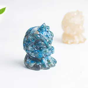 Detail of blue natural crystal stone and resin lion figurine with light reflecting finish