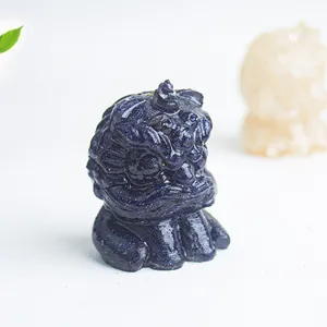 Macro shot of blue sandstone guardian lion figurine with glittering starlight effect