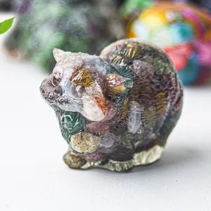 Macro shot of cat figurine with colorful crystal stones in resin for desk decoration