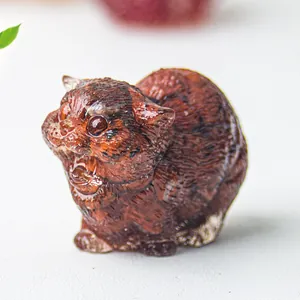 Macro view of cat resin sculpture with natural red crystal stone texture and marble pattern