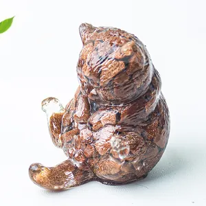 Dettaglio macro di una statuetta di gatto in resina con pietre naturali decorative