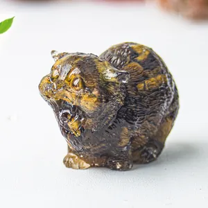 Detailed macro view of a cat figurine crafted from polished natural tiger eye crystal