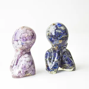 Detailed view of resin statues with embedded purple and blue natural crystal stones