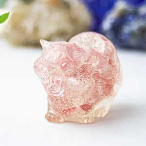 Macro shot of pink natural strawberry quartz cat figurine with detailed fur texture
