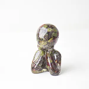Macro detail of abstract thinker statue made of clear resin and natural colorful crystals