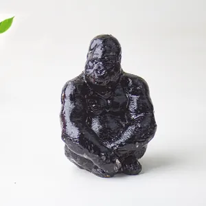 Macro detail of a black resin gorilla statue showing glossy finish and fine textures