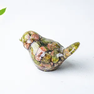 Detailed macro view of bird statue made from resin and unakite natural crystal stone