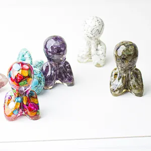 Detailed view of handmade resin meditation statues filled with colorful natural crystals