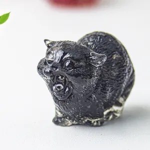 Polished black crystal cat figurine with a wide mouth open for office desk decoration