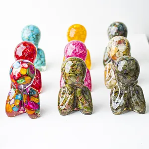 Macro shot of human-shaped resin statues filled with colorful natural crystal stones