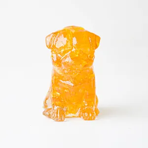 Macro detail of amber resin pug statue with internal natural crystal texture