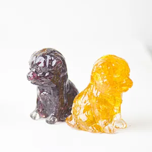 Macro detail of crystalline resin puppy statues in amber and purple translucent finish