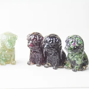 Macro detail of four miniature dog figurines carved from various natural crystal gemstones