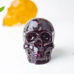 Detailed macro view of dark red natural crystal gravel inside a resin skull ornament