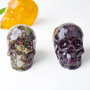 Macro shot of skull resin ornaments filled with natural green and purple crystal stones