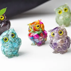 Detailed group view of colorful resin owl figurines with natural crystal stones