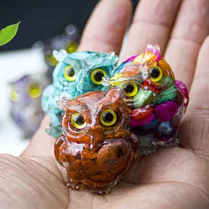 Detailed macro view of resin owl figurines with colorful crystal stone inlays