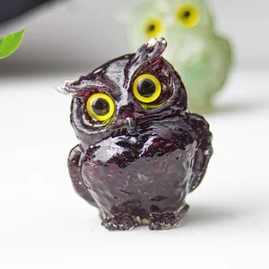 Macro shot of purple resin owl figurine with crystal-like texture and yellow eyes