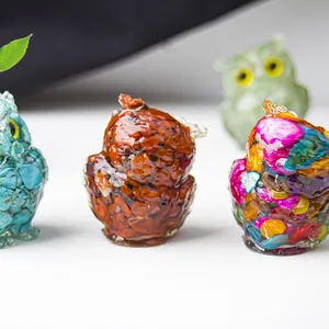 Macro shot of resin owl figurines with colorful natural crystal stone fillings