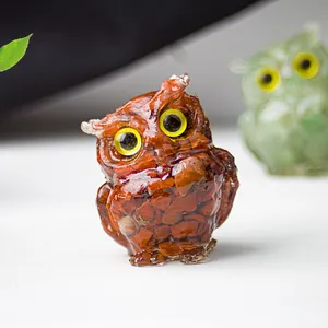 Macro view of crystal owl statue crafted with red jasper stones and transparent resin