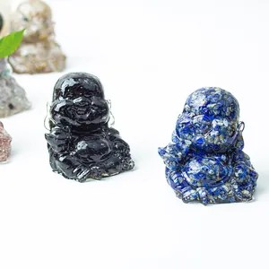 Close-up of laughing Buddha statues in polished black and blue crystal resin